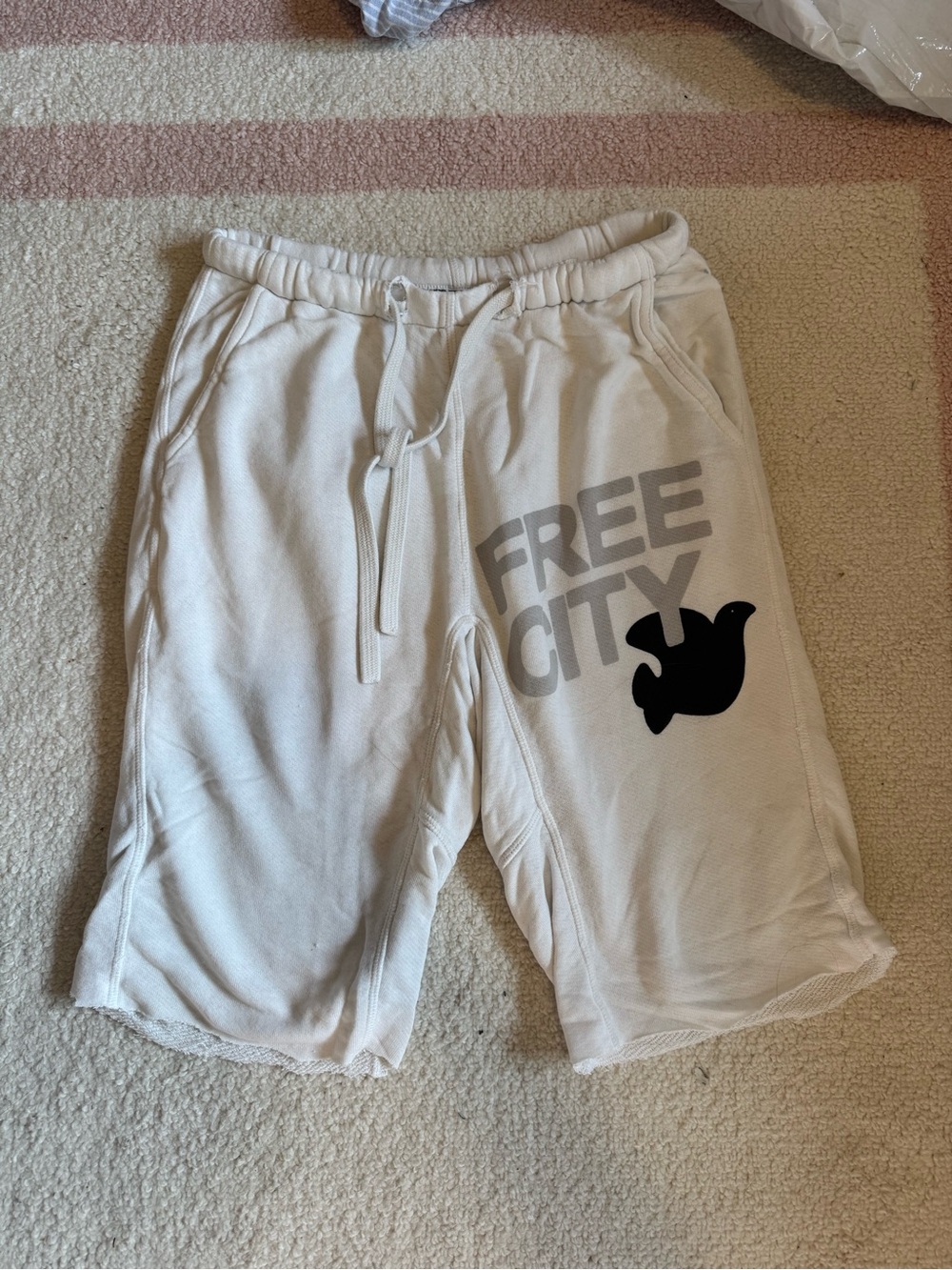 freecity Cream Graphic Shorts with Black Logo